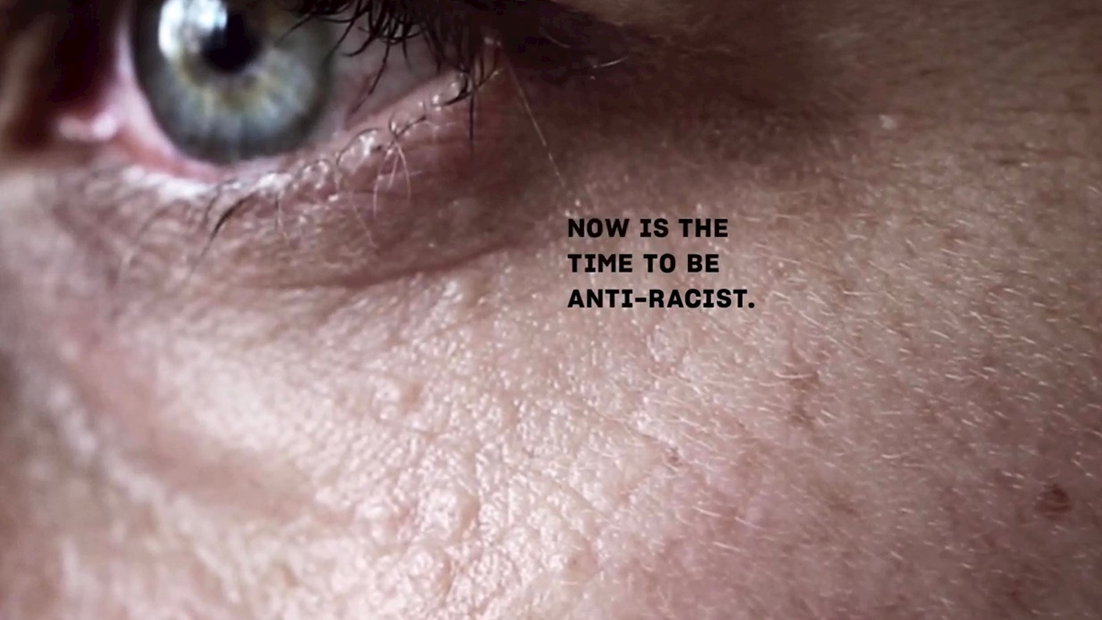 Image of white man's face with words "Now is the time to be anti-racist"
