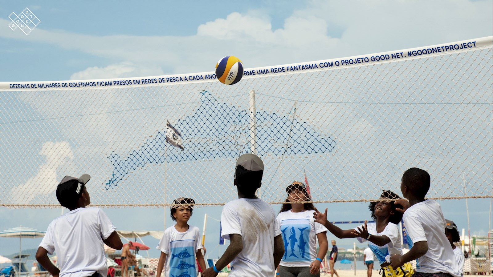 Children playing volleyball with a Good Net project net