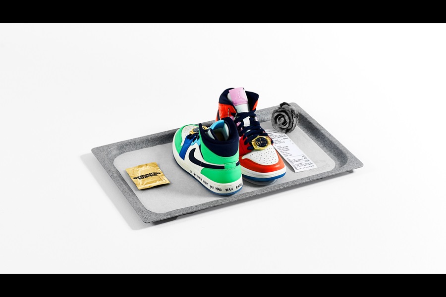 Nike sneakers on food tray alongside wipe, rose and receipt 