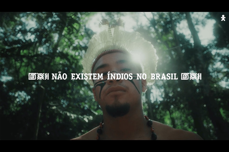 Person from indigenous Brazilian background in front of a canopy of trees