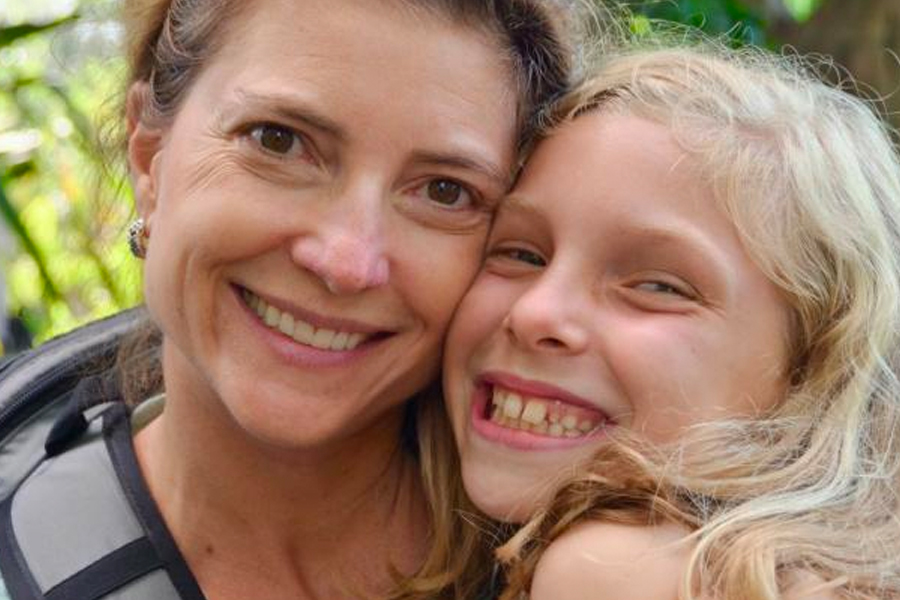 Image of a mother and daughter smiling for a picture