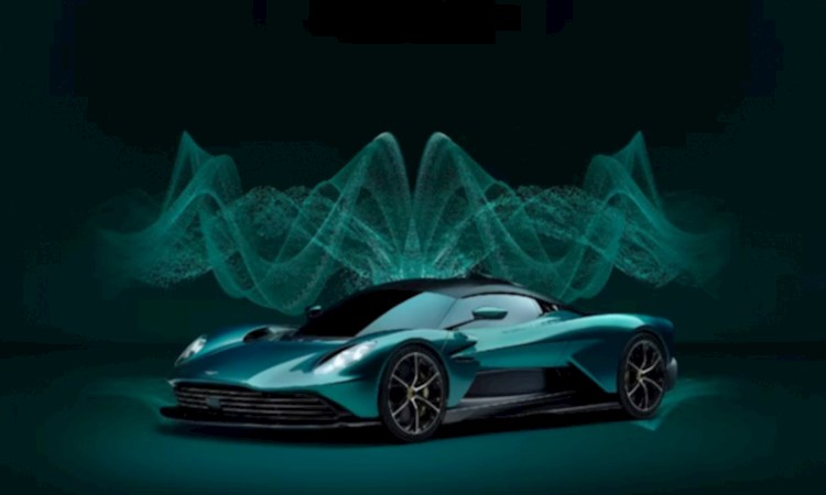 Green Aston Martin Valkyirie car on a green background with glowing green and pulsating visualisations in the background