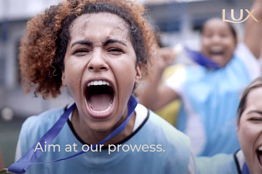 Girl playing sport, screaming with text that reads 'aim at our prowess'