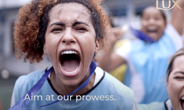 Girl playing sport, screaming with text that reads 'aim at our prowess'