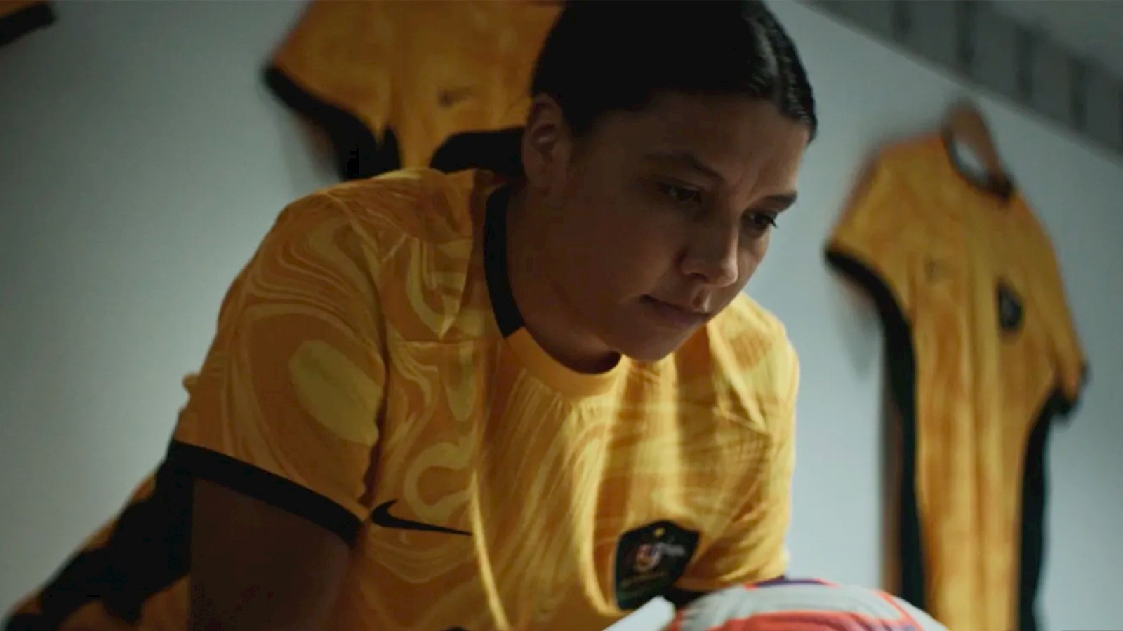 Australian female football player holding ball