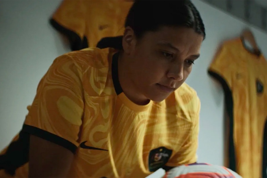 Australian female football player holding ball