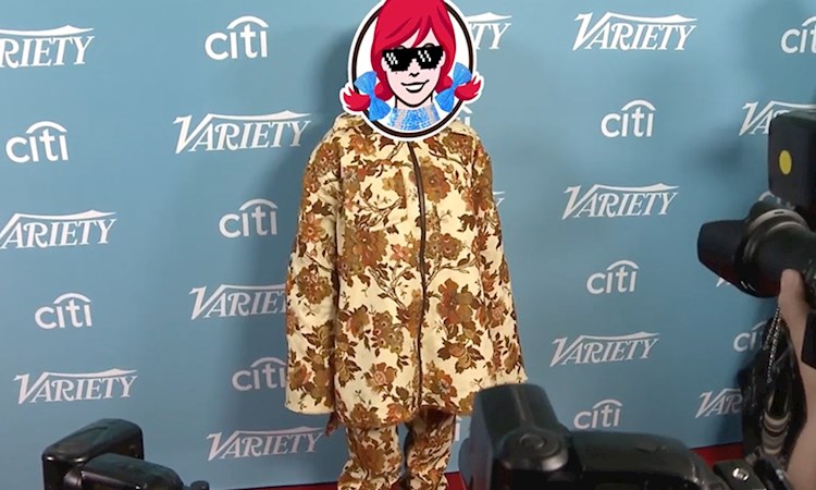 Influencer on the red carpet being photographed with Wendy's head imposed