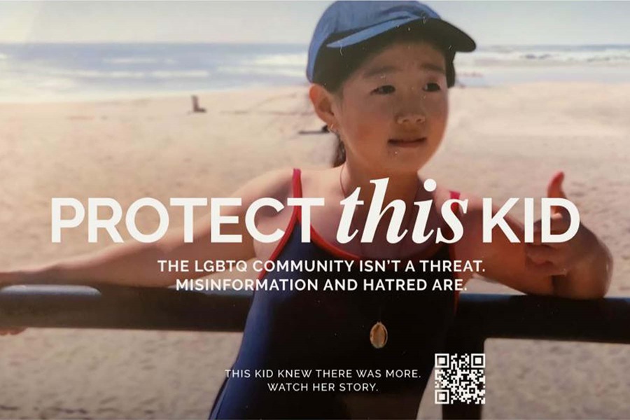 Young girl at the beach with white text overlay saying 'Protect this kid: The LGBTQ community isn't a threat. Misinformation and hatred are." 