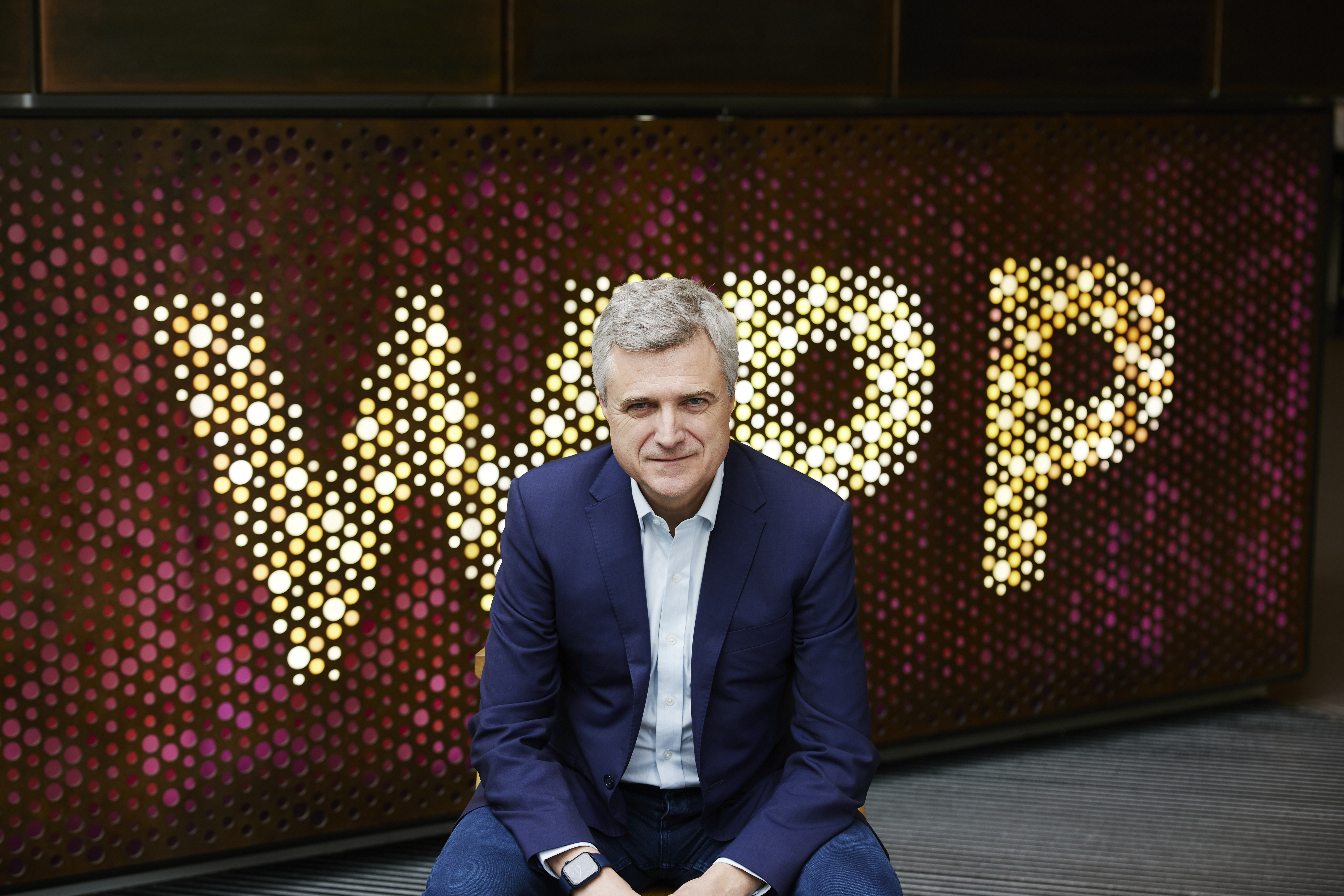 Mark Read sat in front of WPP signage 