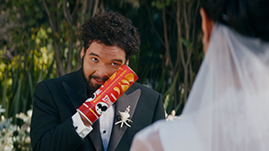 Groom getting married with a Pringles can stuck on his hand
