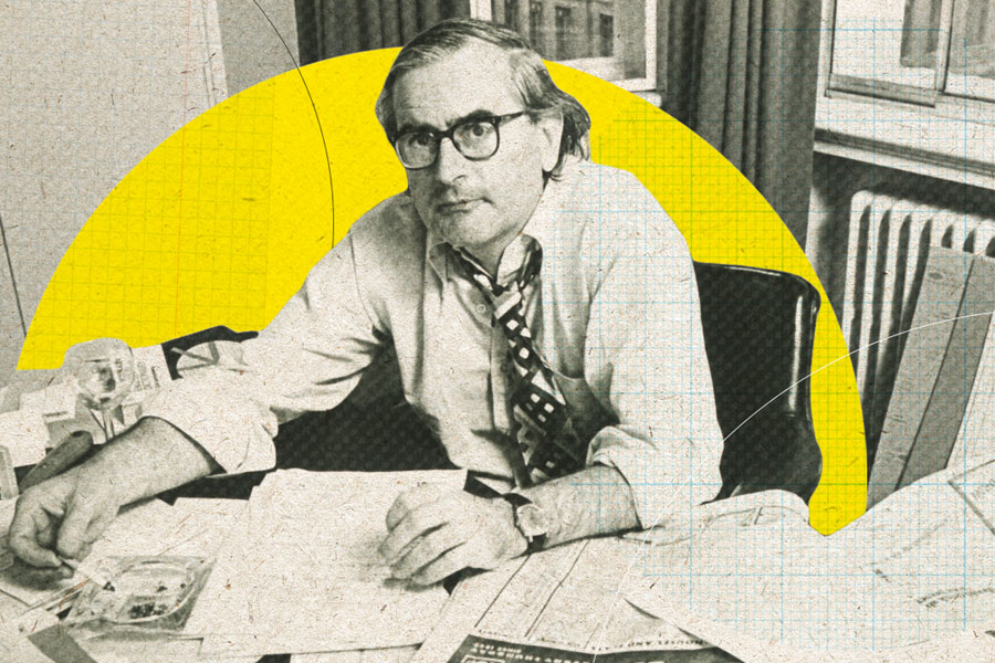 Black and white photograph of Jeremy Bullmore sitting at a desk