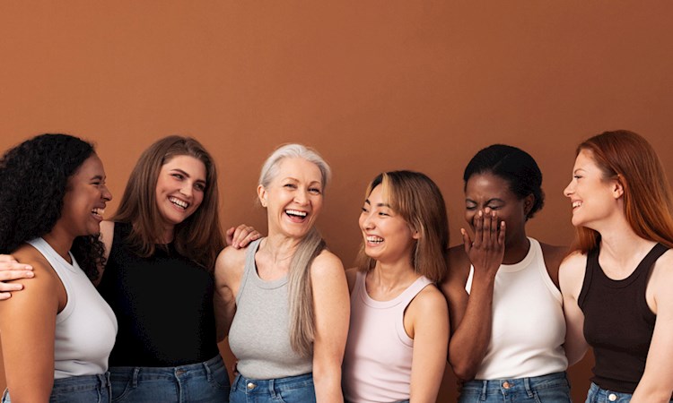 Group of women standing together smiling