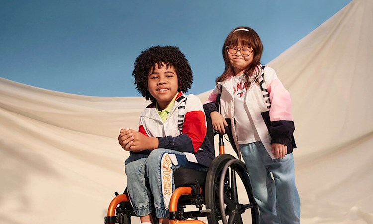 Girl and boy in a wheelchair on blue background, 