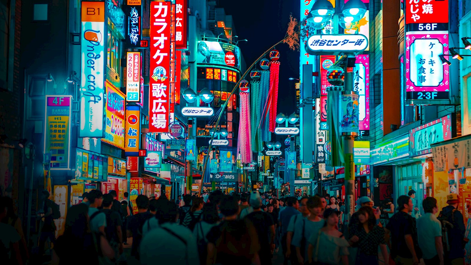 Japanese city landscape with brightly lit street and lots of people