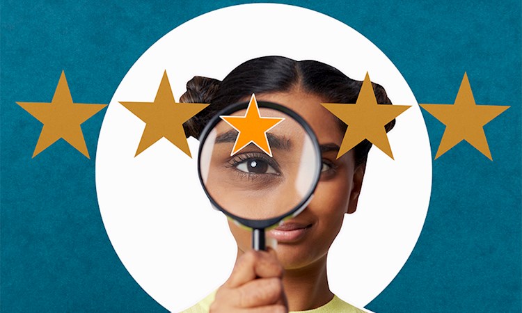 Woman holding magnifying glass to five stars