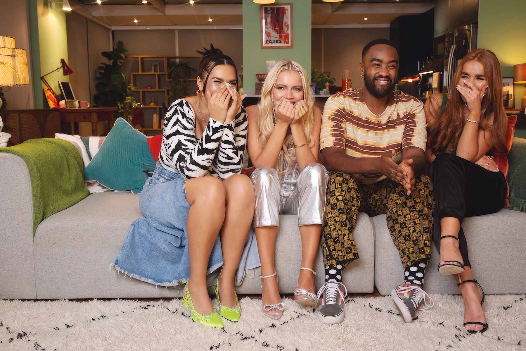 Four people sitting on a sofa wearing clothes from e-Bay 